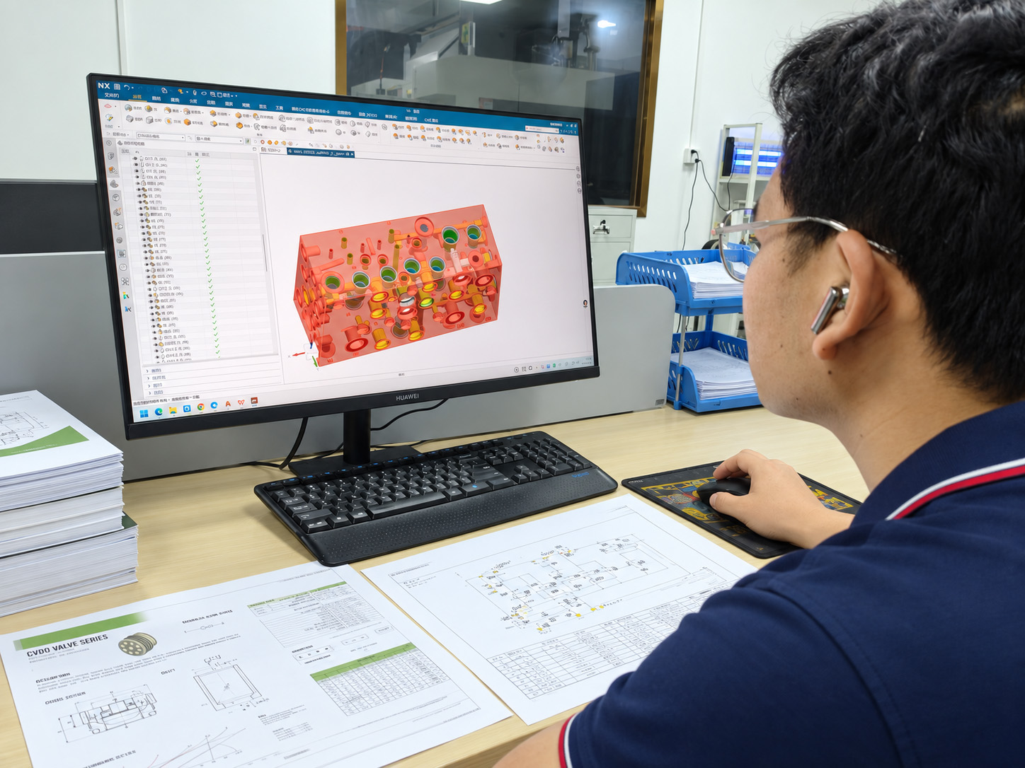 CAD model and component drawings during manifold engineering review.