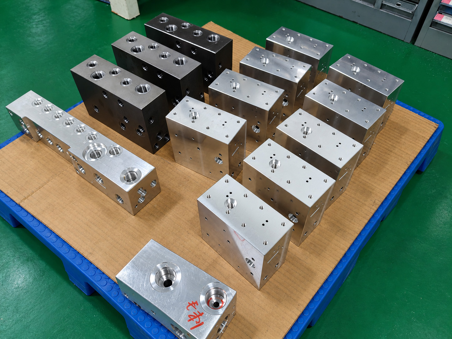 Hydraulic manifold blocks with different surface appearances. The specified finish is confirmed in the project records.