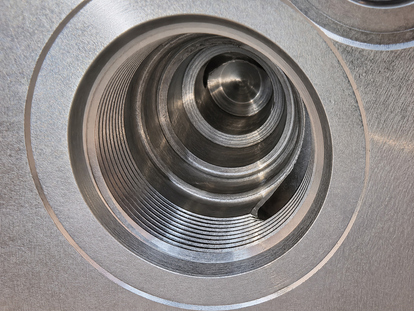 Close-up of a machined valve cavity and a visible internal passage opening.