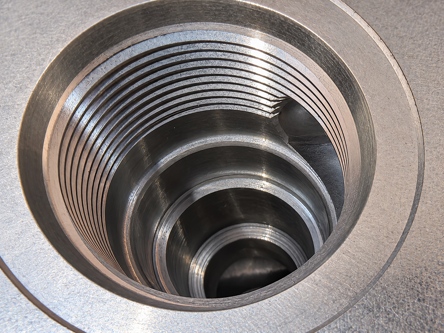Close-up of a valve cavity with machined steps and internal passage openings.
